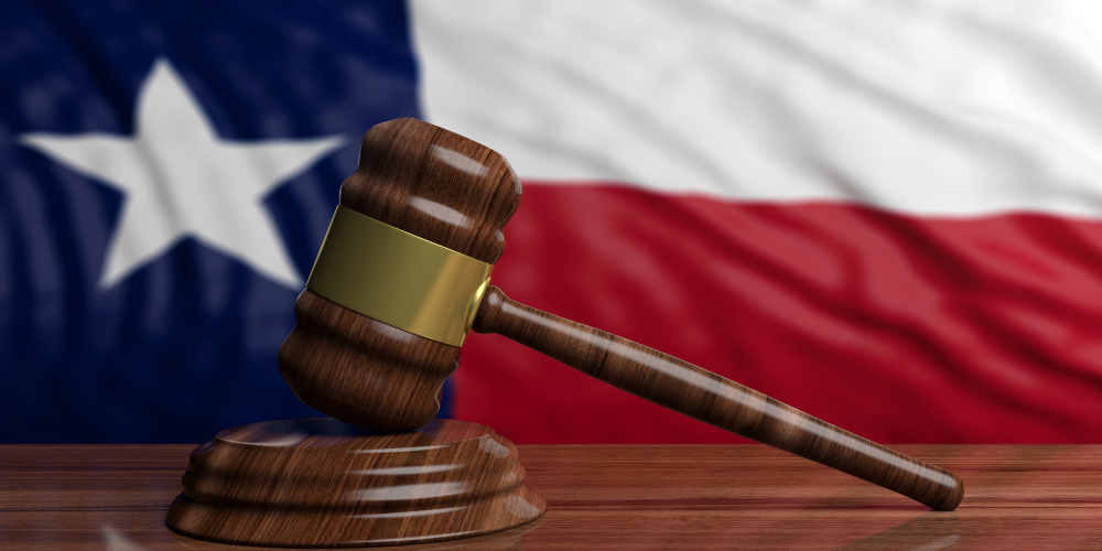 New Texas Laws in Effect for Montgomery County Residents Judge or auction gavel on Texas waving flag background.