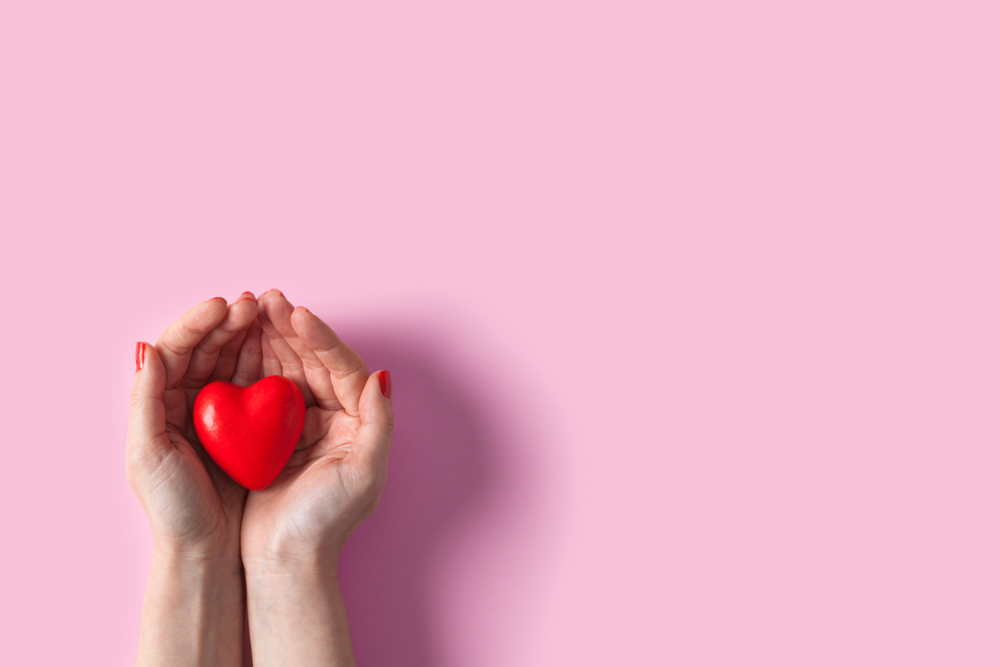 Woman hands holding red heart, health care, donate and family insurance concept, world heart day, world health day, Valentine's day concepts.