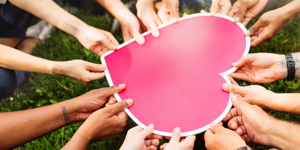 Diverse Hands Holding Pink Heart Many Diverse Hands Hold Heart Together Unity and Love Diverse Men and Women Holding a Heart Together Charity Support and Volunteering Group of People with Heart
