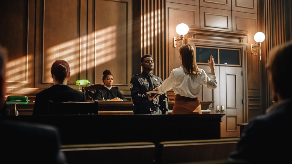 LawAndJusticeCourtCaseWitnessSolemnlySwearsThatThe Witness taking an oath in court during legal proceedings involving evidence and testimony.